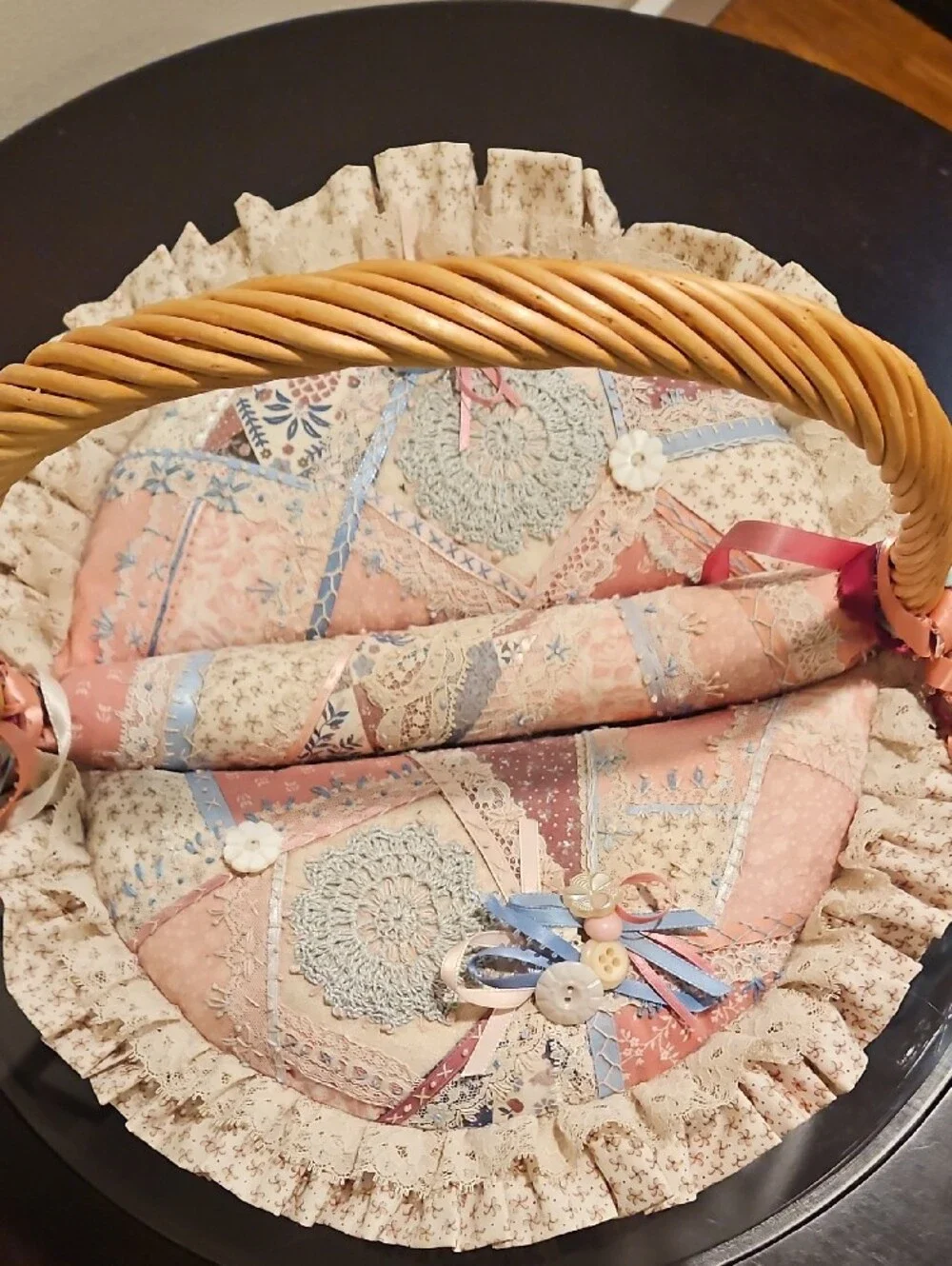 Wicker Basket with Patchwork Lined Cushion and Ribbon Accents